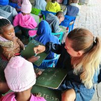Volunteer teaching young children at a local pre-school